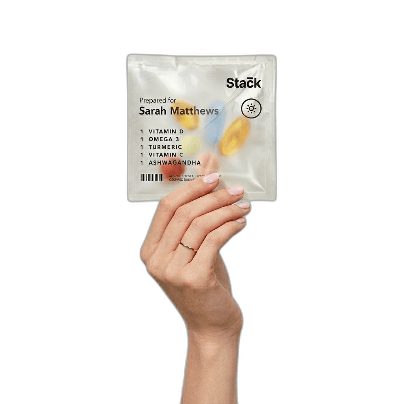 Hand holding a personalized Stack vitamin pack