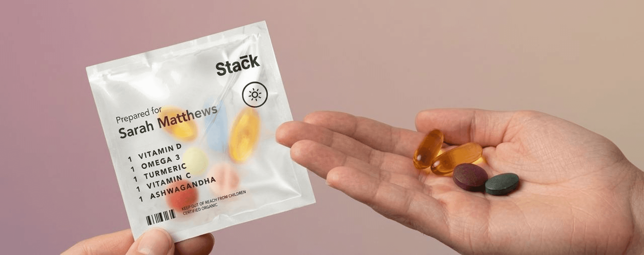 Hands holding Stack supplement sachet and pills