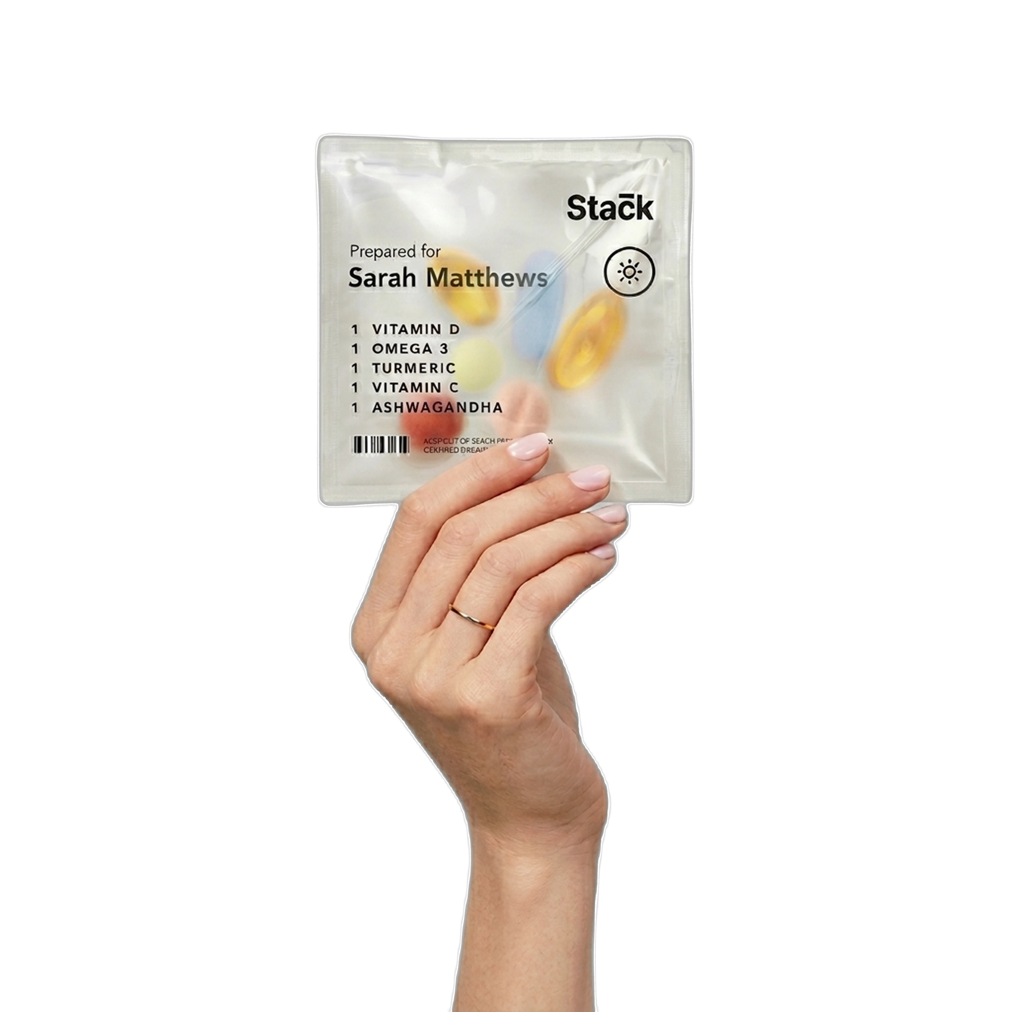 Hand holding a personalized Stack vitamin pack